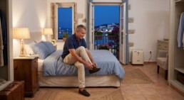 Traveller preparing for the night with an oxygen concentrator in holiday accommodation
