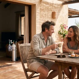 Couple enjoying a holiday while prescribed cluster headache oxygen is ready nearby